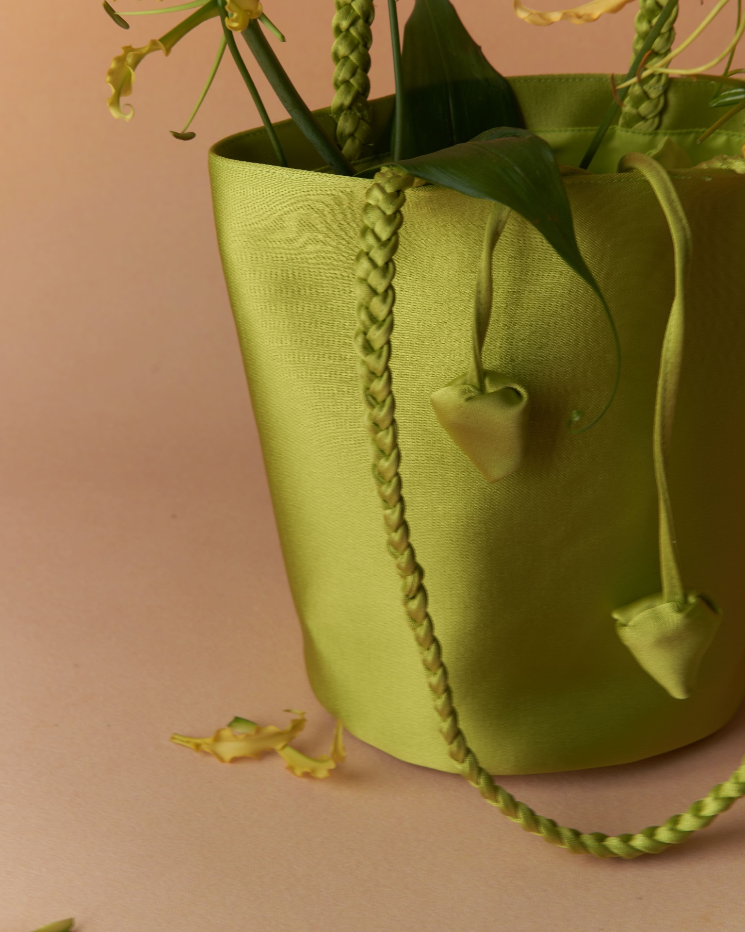 Chartreuse bucket bag detail with braided strap