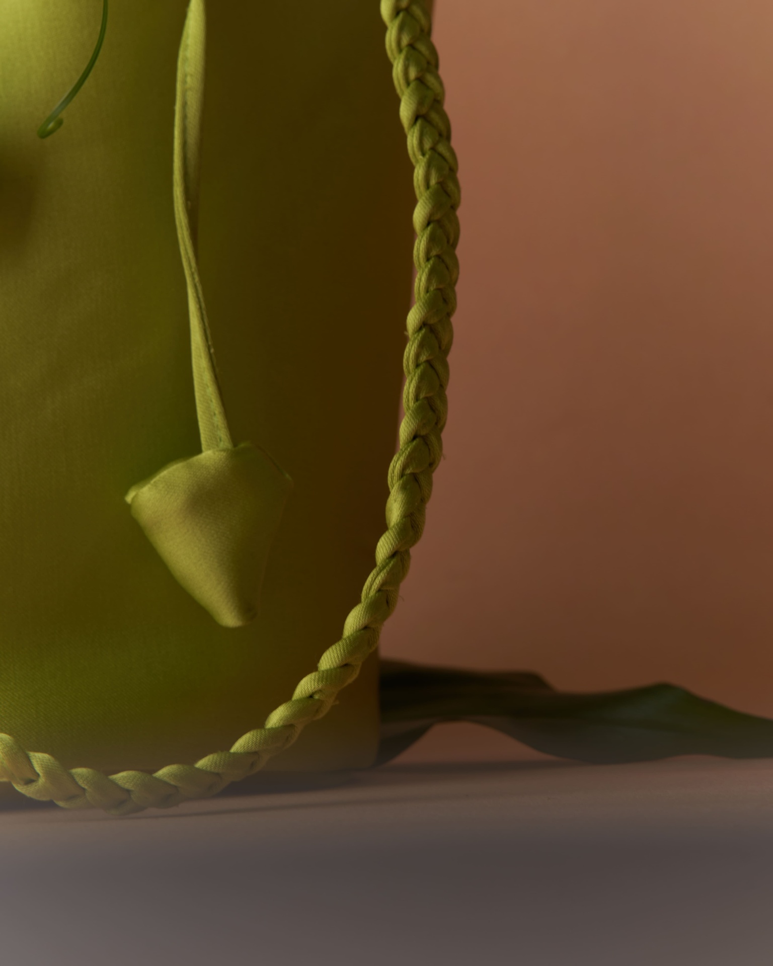 Close-up of chartreuse braided strap and tassel