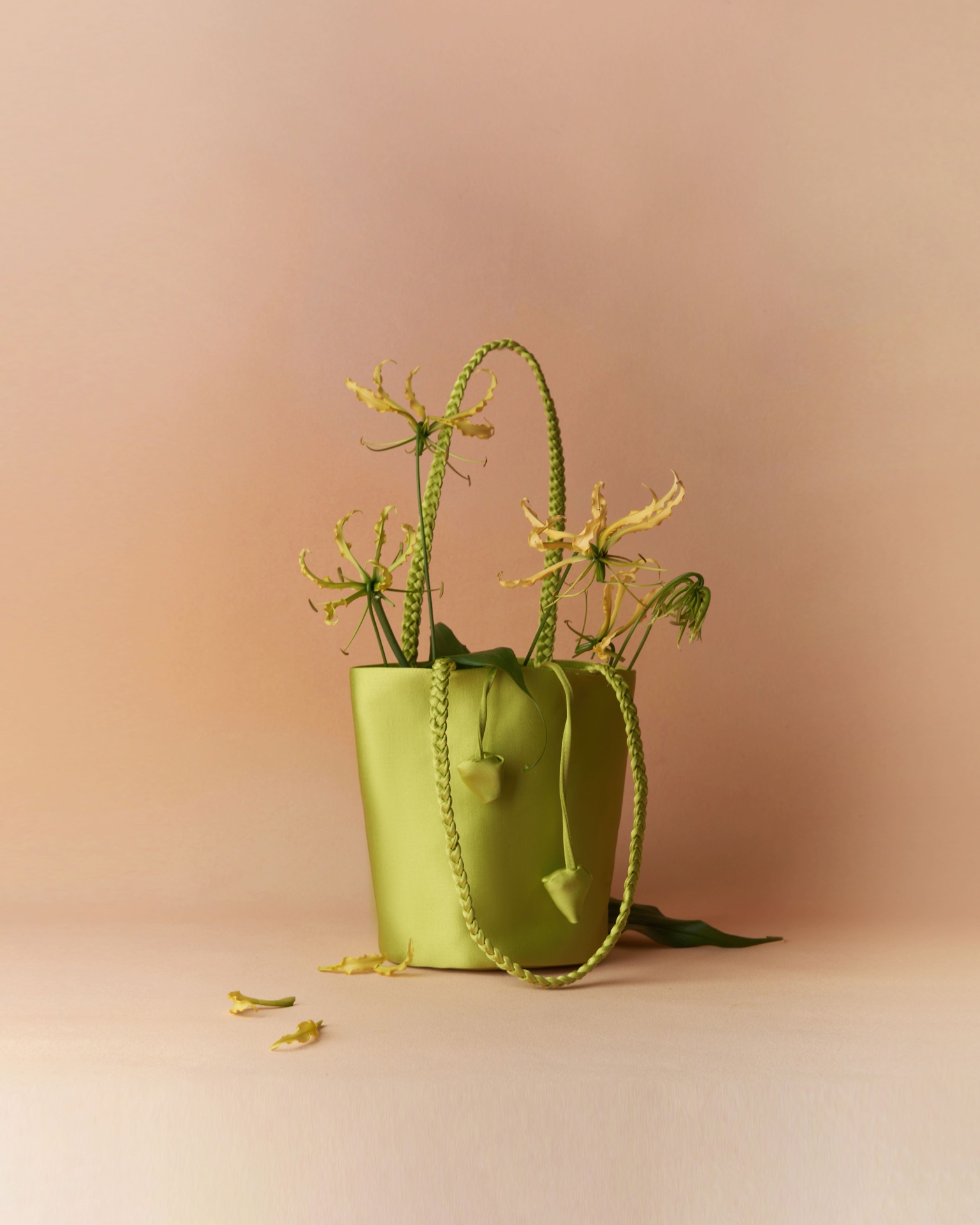 Chartreuse satin bucket bag with gloriosa lilies