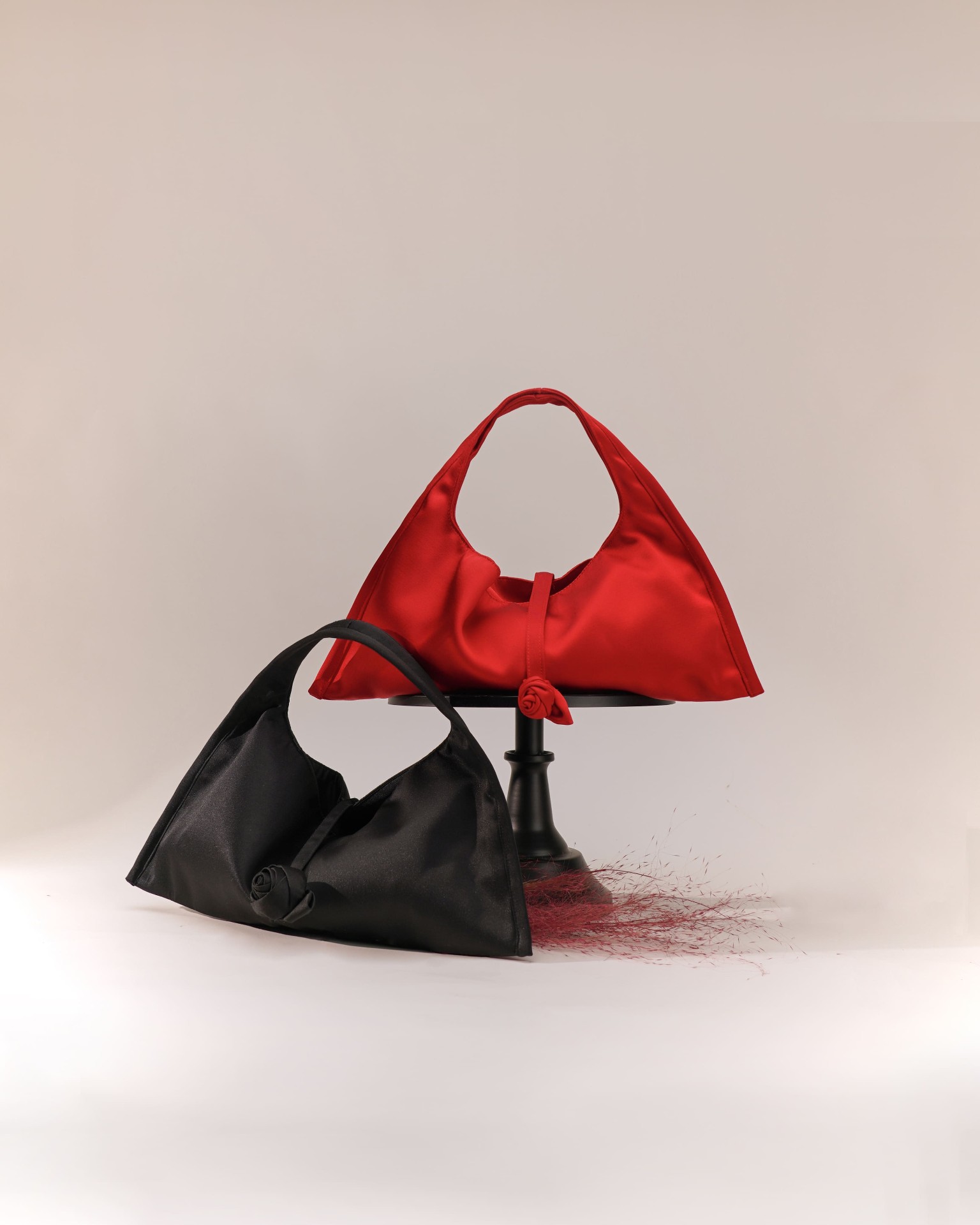 BBold red and black satin shoulder bags with rose detail